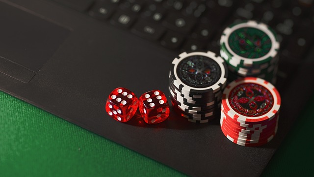 Dice and poker chips on laptop