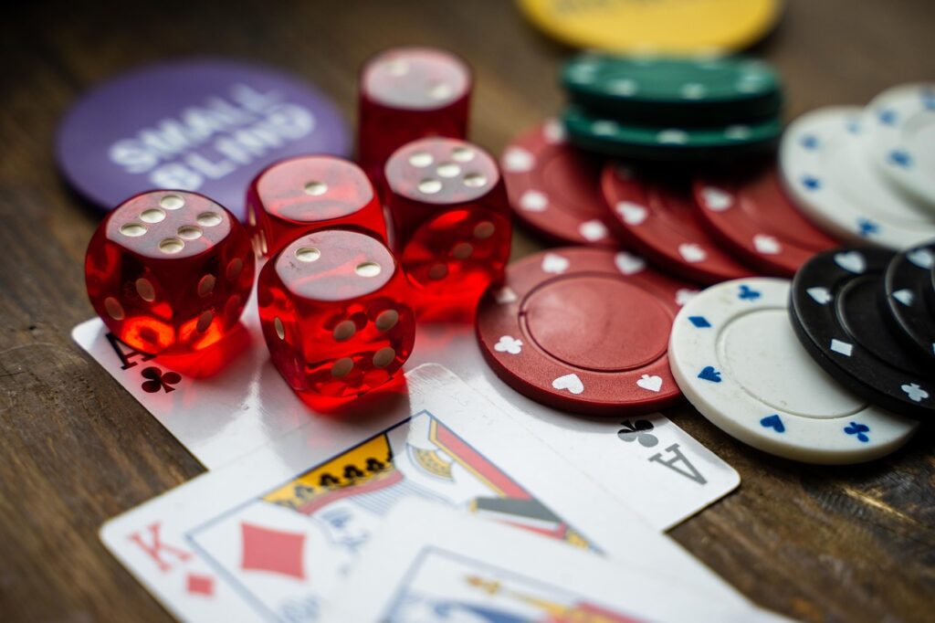 Dice and poker chips on cards